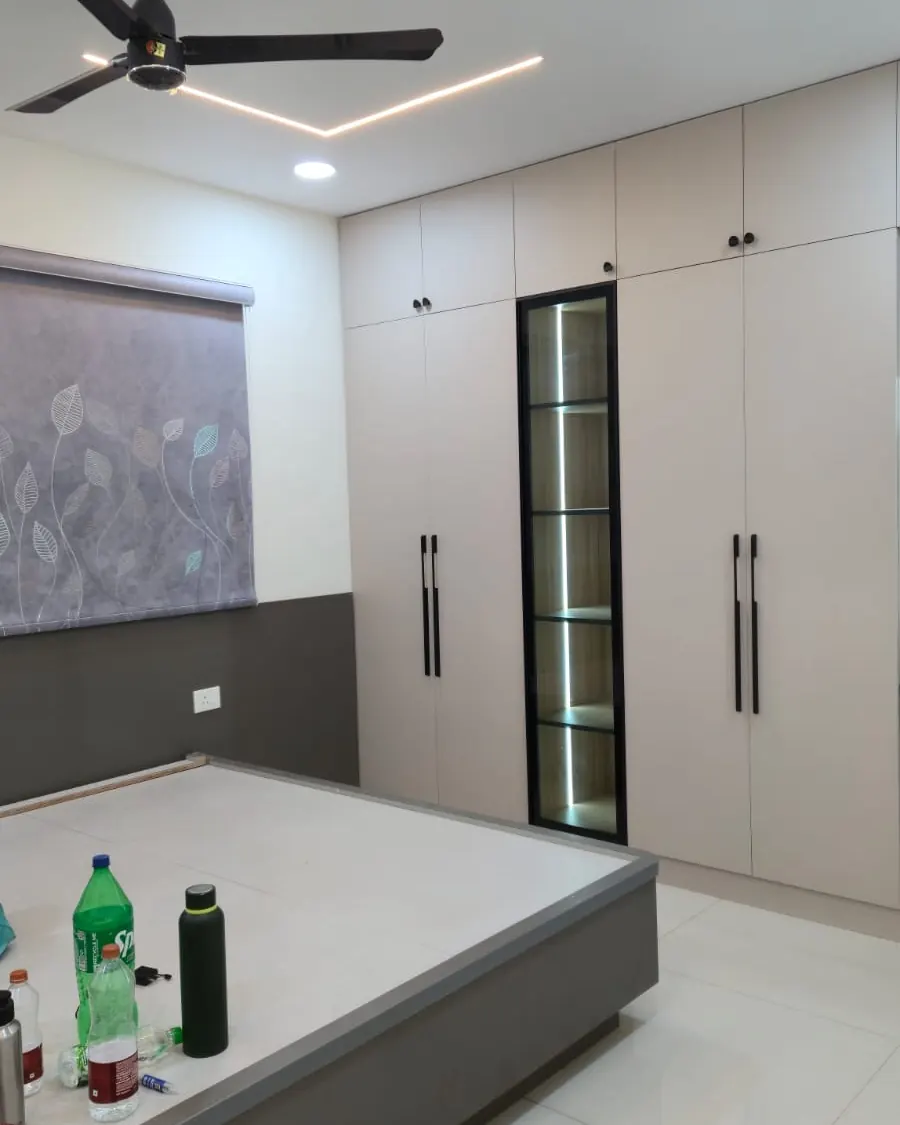 Bedroom with a full-height wardrobe and a false ceiling with a lit cove