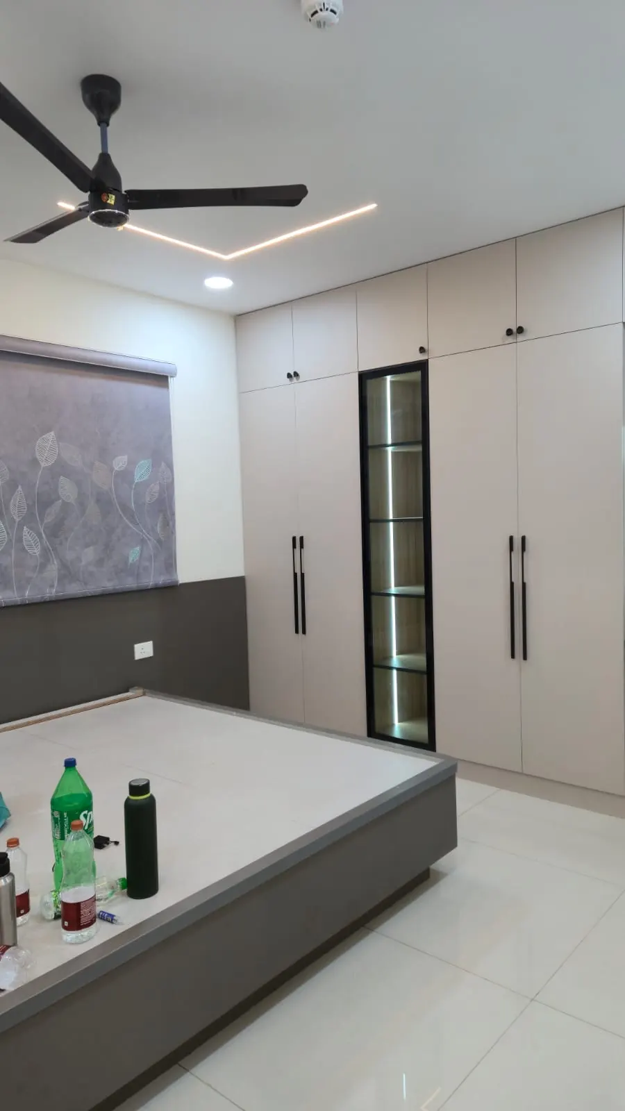 Bedroom with a full-height wardrobe and a false ceiling with a lit cove