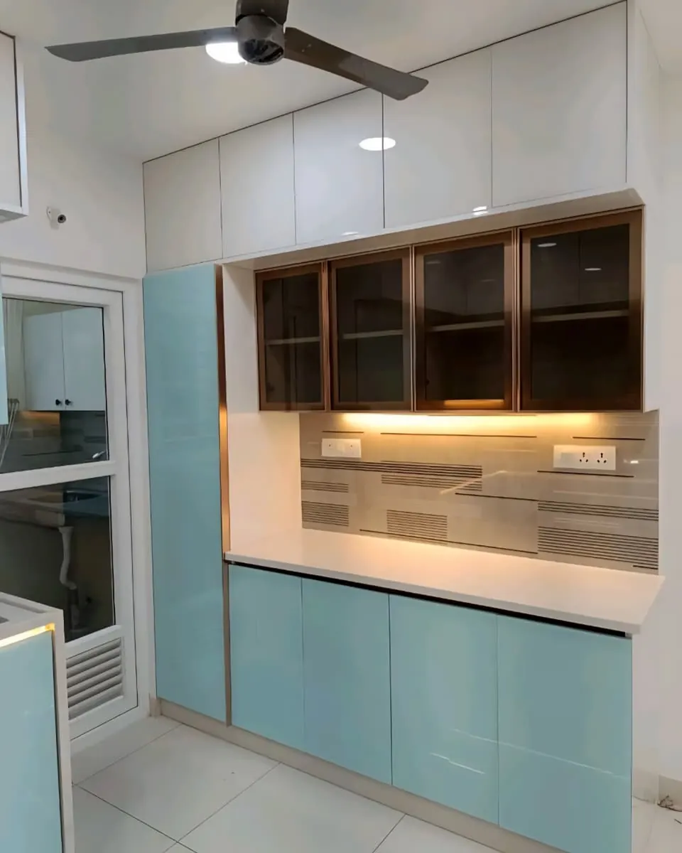 Crockery unit with glass-front cabinets, a lit open niche and pale blue lower shutters