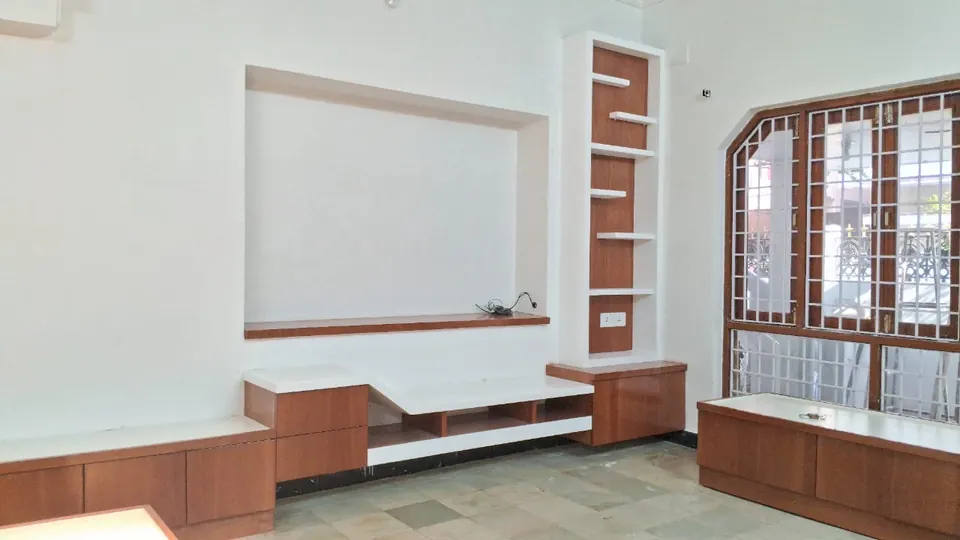 Wall unit with a recessed niche, side shelves and a low wood-finish cabinet